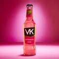 A bottle of VK Watermelon, a ready-to-drink alcoholic beverage with a pink label and watermelon design, against a pink background.