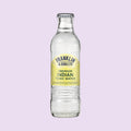 A glass bottle of Franklin & Sons Premium Indian Tonic Water with a white and yellow label, indicating it is a premium beverage.
