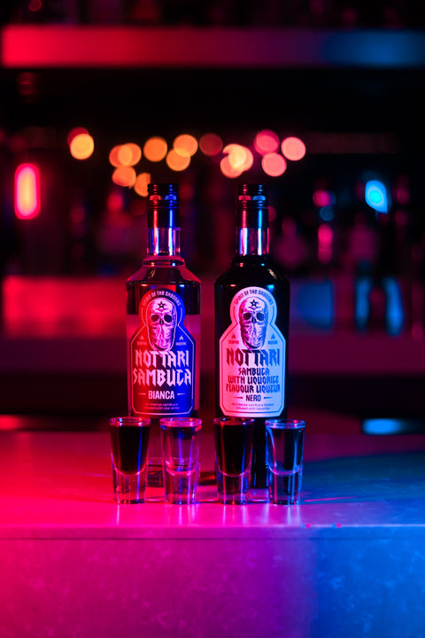 Bottles of Nottari Sambuca with shots in front of the bottles.