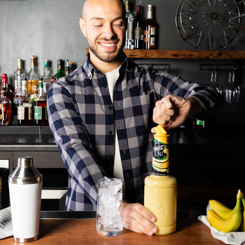 Someone making a cocktail using Finest Call banana, perfect for making cocktails and mocktails. 