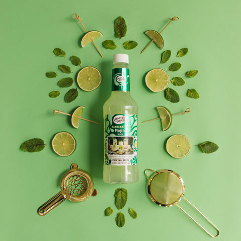 Bottle of Master of Mixes Mojito on a green background with lime slices and mint leaves.