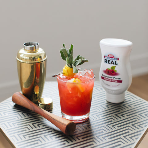 A raspberry cocktail made using Reál raspberry syrup, a vegan and gluten-free syrup that's a prefect cocktail ingredient. 