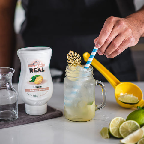 Someone making a ginger drink using Real ginger infused syrup, Real syrups are gluten-free and vegan. 