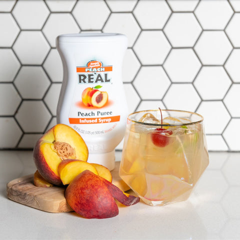 A peach cocktail made using Real peach puree syrup, a vegan and gluten free syrup that is a perfect cocktail ingredient. 