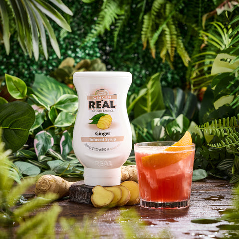 A ginger cocktail made using Real ginger infused syrup, with the Real syrup next to it, Real syrups are gluten-free and vegan. 