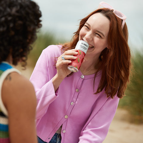 Someone drinking All Shook Up strawberry daiquiri premixed, ready to drink canned cocktail.