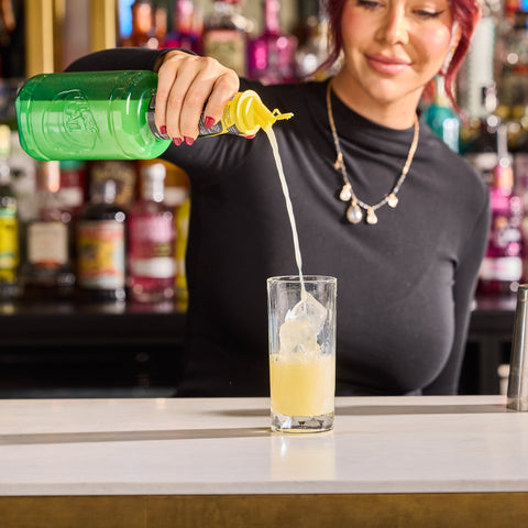 Finest Call Single Pressed Lemon Juice pour into glass with ice