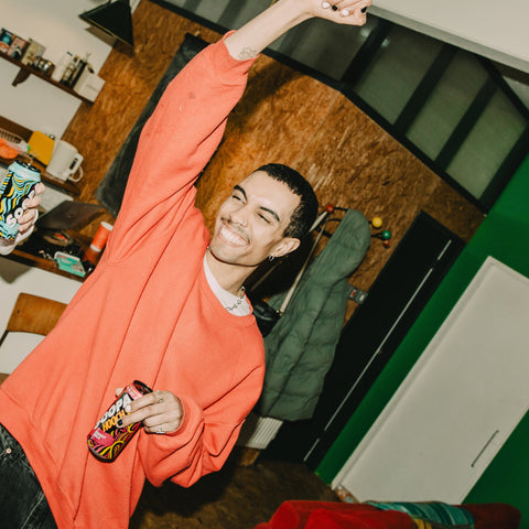 Someone at a party drinking Soopa Hooch cherry cola ready to drink can. 