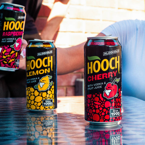 Three cans of Hooch in flavours cherry, lemon and raspberry, premixed and ready to drink alcopops. 