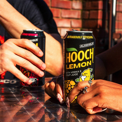 People drinking two cans of Hooch, Hooch Cherry and Hooch Lemon, a premixed vodka alcopop.