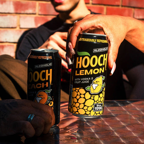 Two cans of Hooch, lemon Hooch and Peach Hooch, alcopops made with vodka and fruit juice. 