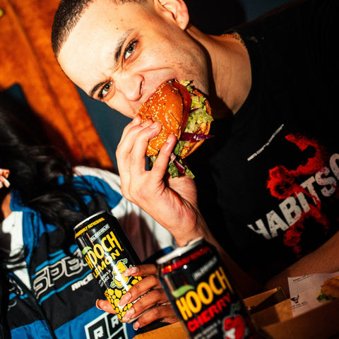 People eating food and drinking Hooch ready to drink alcopops. 