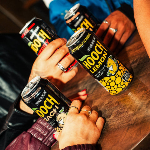 People drinking cans of Hooch in flavours, lemon, cherry and peach, Hooch is a ready to drink alcopop. 