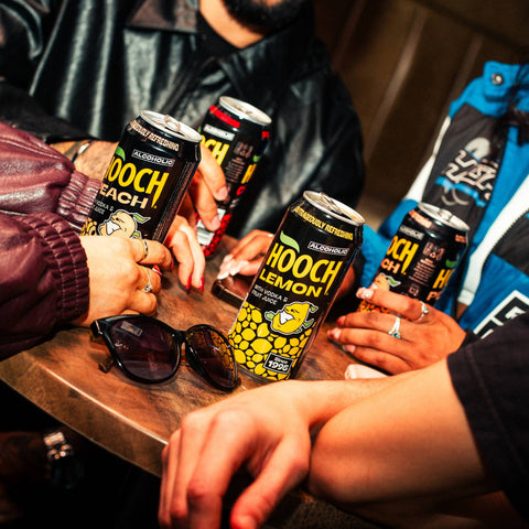 People drinking cans of Hooch in flavours, lemon, cherry and peach, Hooch is a ready to drink alcopop. 
