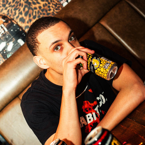 A person drinking a can of Lemon Hooch, a premixed, ready to drink alcoholic lemonade. 