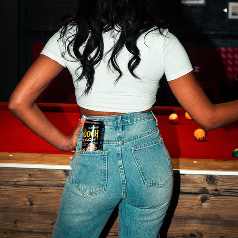 A can of Hooch Peach, a premixed alcopop, in the back of someone's pocket. 