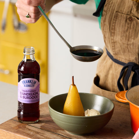 Someone making a dessert with a bottle of Franklin & Sons premium soft drink, traditional dandelion & burdock. 