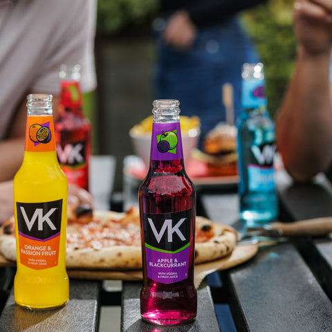 People eating pizza and drinking VK, vodka mix, ready to drink alcopops. 