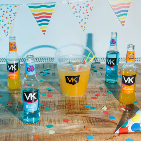 Displaying the Pres pack (OG Flavours) lifestyle with partly drunk bottles of VK Blue and VK Orange & Passionfruit next to a VK Cocktail Bucket