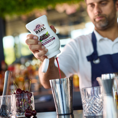 Real infused exotics black cherry puree infused syrups squeezed into cocktail shaker