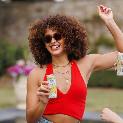 Someone at a party drinking All Shook Up Elderflower and mint spritz. 