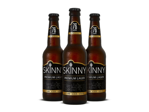 Three bottles of Skinny Premium Lager on a white background