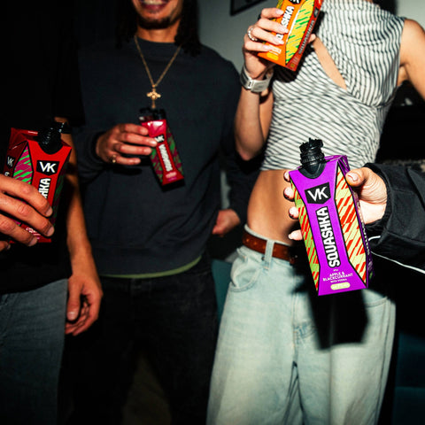 People holding.VK Squashka drinks in a casual setting