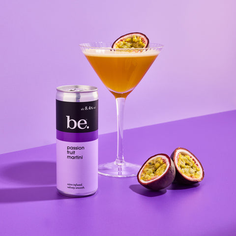 Luxury Passion Fruit Martini next to a be. Passion Fruit Martini canned cocktail