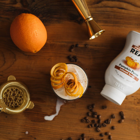 A pumpkin latte made using Reál pumpkin puree syrup, Reál syrups are perfect for cooking & baking, making cocktails or mocktails and dirty sodas. 