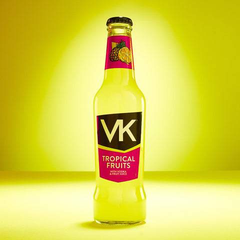 A bottle of VK tropical fruits alcopop on a yellow background. 