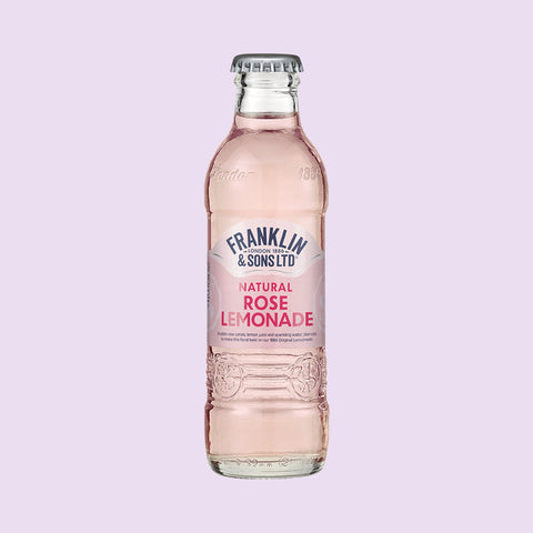 A glass bottle of Franklin & Sons Natural Rose Lemonade, a premium soft drink. 