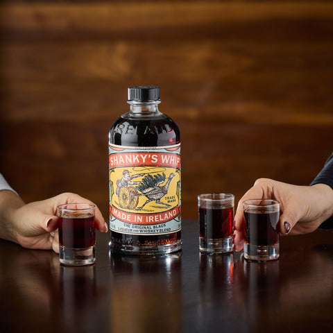 People drinking shots of Shanky's Whip Irish liqueur and whiskey blend. 