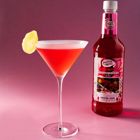 A bottle of Master of Mixes Cosmopolitan cocktail mixer, with a Cosmopolitan cocktail next to the bottle.