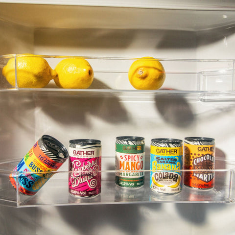 Cans of GATHER in the fridge door with lemons. 