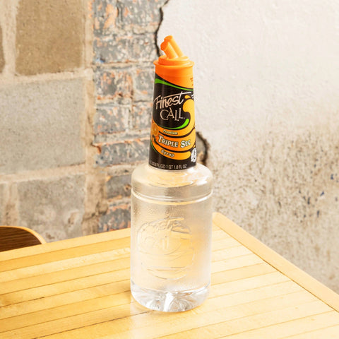 A bottle of Finest Call Premium Triple Sec syrup, a non-alcoholic syrup, perfect for making cocktails and mocktails. 