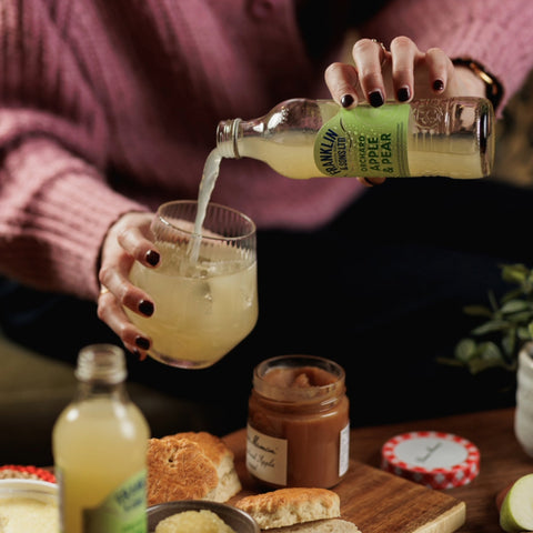 someone pouring FS Orchard Apple & Pear into a glass