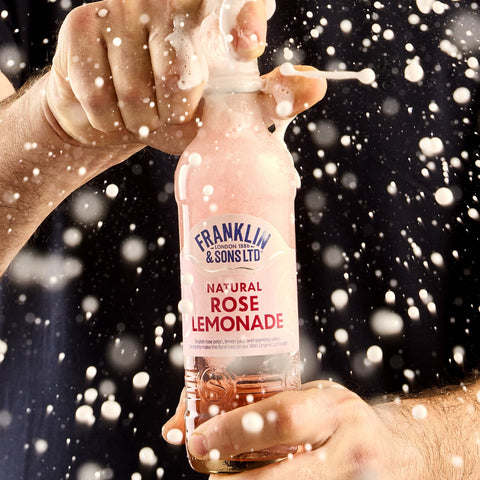 Someone opening a bottle of Franklin & Sons rose lemonade a premium soft drink. 