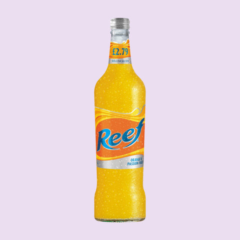 A bottle of Reef Orange & Passion Fruit flavoured alcoholic beverage bottles with a colourful design on the packaging, on a light purple background. 