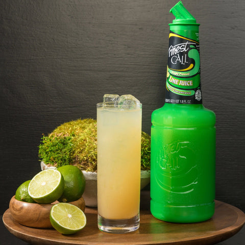 Finest Call Single Pressed Lime Juice at with a cocktail and limes