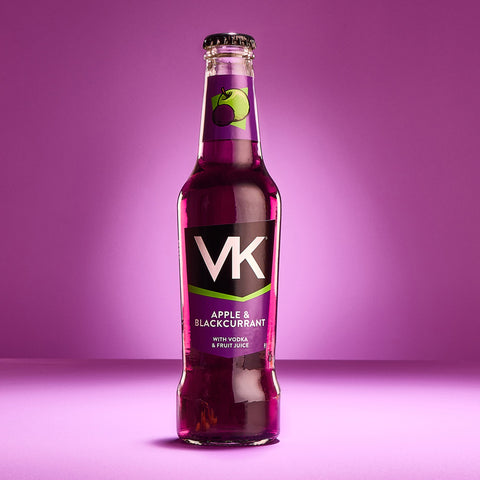 A bottle of VK Apple & Blackcurrant flavoured alcopop against a purple background, showcasing the brand's logo and the product name.