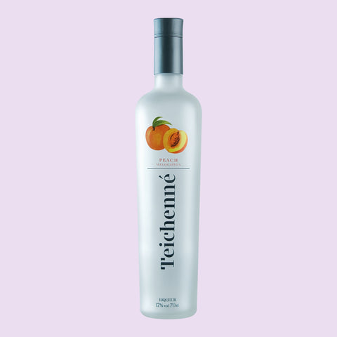 A bottle of Teichenné Peach Schnapps Liqueur placed, a drink perfect for easy shots, making cocktails or mixing.