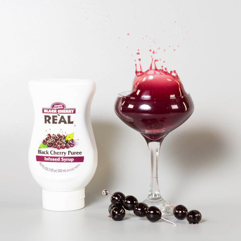 Real cherry infused syrup bottle by glass