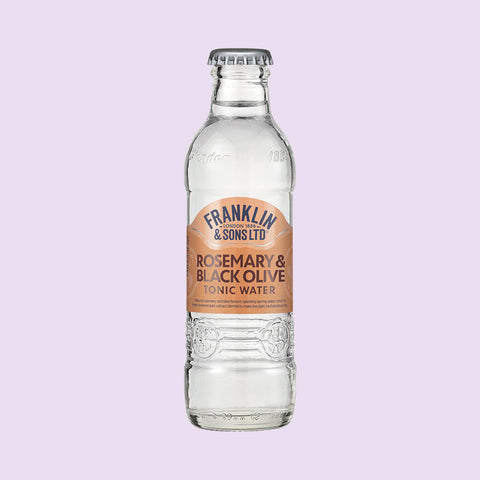 A glass bottle of Franklin & Sons Rosemary & Black Olive Tonic Water, a premium mixer. 