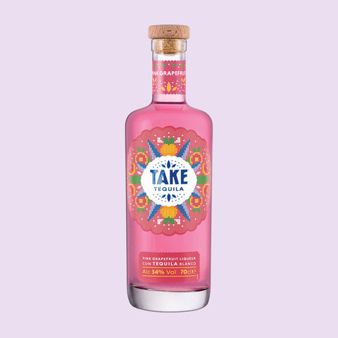 A bottle of Take Pink Grapefruit Tequila Liqueur with a colourful label, with a light purple background. 