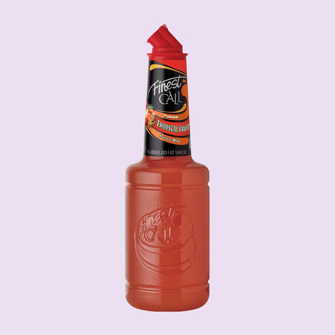 Bottle of Finest Call tropical fruit juice mix on a light purple background