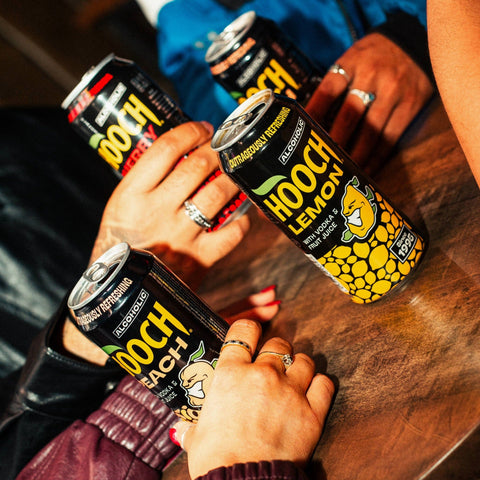 People drinking cans of Hooch in flavours, lemon, cherry and peach, Hooch is a ready to drink alcopop. 