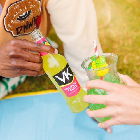 Someone drinking VK tropical fruits vodka mix, ready to drink alcopop.