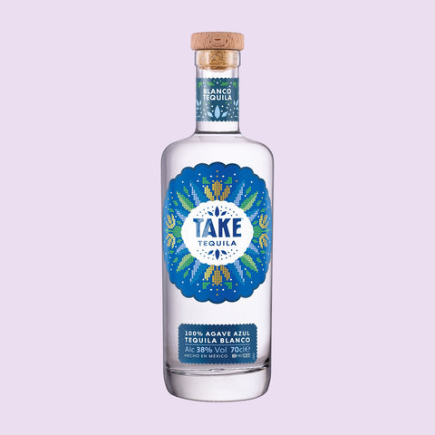 A bottle of Take Tequila Blanco on a light purple background. 