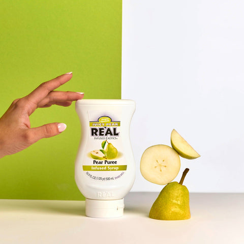 Someone grabbing a bottle of Re'al Juicy Pear Puree Infused Syrup. 