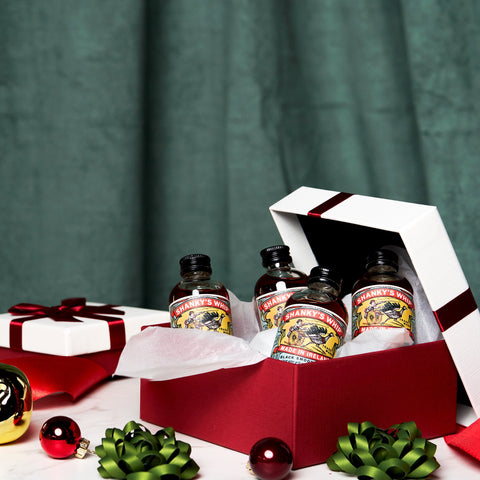 A Christmas present that has four bottles of Shanky's Whip miniatures. 